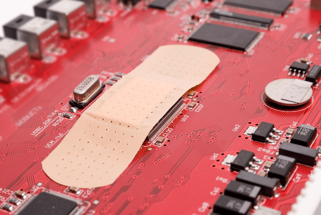 Image of a bandage on a motherboard that represents the necessity of patch management